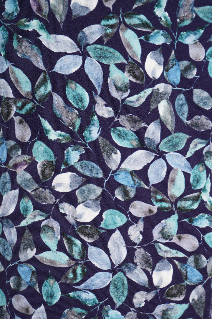 A close up of the leafy pattern top on a navy background.