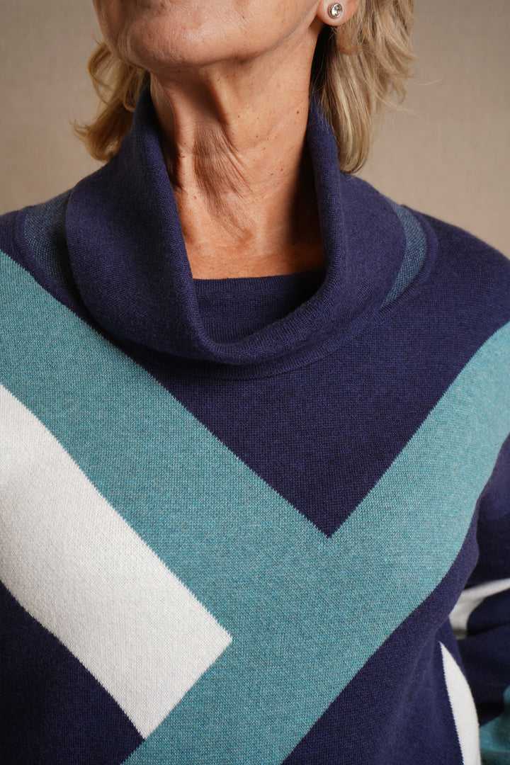 Navy sweater with geometric pattern worn by a person